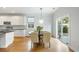 Well-lit dining area with hardwood floors, modern light fixture, and access to the outdoor patio at 2187 Annie Laura Ln, Mount Pleasant, SC 29466