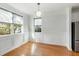 Bright dining room with beautiful hardwood floors, modern light fixture, and wainscoting at 2187 Annie Laura Ln, Mount Pleasant, SC 29466