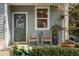 Charming front porch featuring rocking chairs, lush plants, and a green front door at 2187 Annie Laura Ln, Mount Pleasant, SC 29466