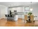 Well-lit kitchen with white cabinetry, granite countertops, and a center island with seating at 2187 Annie Laura Ln, Mount Pleasant, SC 29466