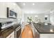 Modern kitchen featuring stainless steel appliances, granite countertops, and a view of the dining room at 2187 Annie Laura Ln, Mount Pleasant, SC 29466