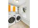 Bright laundry room boasts a washer, dryer, tiled floor, and shelving at 2187 Annie Laura Ln, Mount Pleasant, SC 29466
