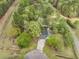 An aerial view of a charming home nestled among lush, mature trees, offering privacy and a natural setting at 220 New Oak Ln, Moncks Corner, SC 29461