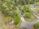 A charming home features a beautiful pool surrounded by lush trees and greenery from an aerial view at 220 New Oak Ln, Moncks Corner, SC 29461