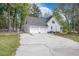Exterior view of home featuring a two-car garage and a concrete driveway at 220 New Oak Ln, Moncks Corner, SC 29461