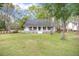 Charming single-story home featuring a cozy front porch and well-maintained lawn at 220 New Oak Ln, Moncks Corner, SC 29461