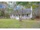 Charming single-story home with a welcoming front porch and manicured lawn at 220 New Oak Ln, Moncks Corner, SC 29461