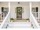 Welcoming front porch with decorative wreath, flower pots and house number at 220 New Oak Ln, Moncks Corner, SC 29461