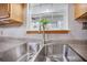 Close up of the stainless steel sink with a garden view at 220 New Oak Ln, Moncks Corner, SC 29461