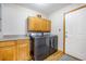 Well-equipped laundry room features side-by-side washer and dryer and cabinet space at 220 New Oak Ln, Moncks Corner, SC 29461