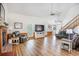 Bright and airy living room with fireplace, wainscoting and wood-look flooring at 220 New Oak Ln, Moncks Corner, SC 29461