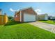 Garage and driveway showcasing well-maintained lawn in a neighborhood at 226 Killarney Trl, Moncks Corner, SC 29461