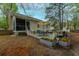 Inviting backyard features a screened porch, patio with seating, and lovely landscaping at 234 Lipman St, Summerville, SC 29483