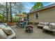 Large backyard patio with seating, a fire pit, a shade umbrella, and a well-manicured yard at 234 Lipman St, Summerville, SC 29483