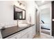 Modern bathroom features a vessel sink, dark countertop, subway tile backsplash, and walk-in access to the main bedroom at 234 Lipman St, Summerville, SC 29483