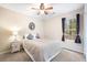 Cozy bedroom with neutral tones, ceiling fan, and window with tree view at 234 Lipman St, Summerville, SC 29483