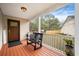 Inviting front porch with black bench, wood flooring, and view of the backyard at 234 Lipman St, Summerville, SC 29483