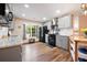 Kitchen with grey cabinets, stainless appliances, natural light from window, and wood laminate flooring at 234 Lipman St, Summerville, SC 29483