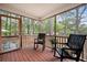 Inviting screened porch with rocking chairs, perfect for outdoor relaxation and enjoying tree view at 234 Lipman St, Summerville, SC 29483