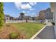 Backyard featuring a well-maintained lawn, landscaping, and a white picket fence at 2681 Park West Blvd, Mount Pleasant, SC 29466