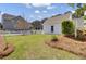 Landscaped backyard with lawn, white picket fence and landscaping, with view of neighboring houses at 2681 Park West Blvd, Mount Pleasant, SC 29466