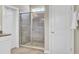 Bright bathroom with a glass-enclosed tiled shower, and a wooden-look tiled floor at 2681 Park West Blvd, Mount Pleasant, SC 29466