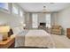 Bright bedroom features a bed, desk, and chair with three windows for ample natural light at 2681 Park West Blvd, Mount Pleasant, SC 29466