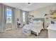 A cozy bedroom with a double bed, storage shelves, natural light, and soft décor at 2681 Park West Blvd, Mount Pleasant, SC 29466