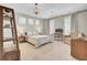 Bright bedroom features a bed, desk, and bookshelf with three windows for ample natural light at 2681 Park West Blvd, Mount Pleasant, SC 29466