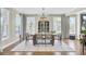 Dining room boasts a modern chandelier, large windows, and stylish dining furniture at 2681 Park West Blvd, Mount Pleasant, SC 29466