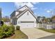 Exterior showcasing a two-story home with white siding, a garage, and a white picket fence at 2681 Park West Blvd, Mount Pleasant, SC 29466