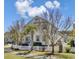 Charming two-story home with manicured lawn and a white picket fence at 2681 Park West Blvd, Mount Pleasant, SC 29466