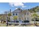 Charming white two-story home featuring a welcoming front porch and landscaped yard with a white picket fence at 2681 Park West Blvd, Mount Pleasant, SC 29466