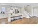 Bright kitchen with stainless steel appliances, kitchen island, and stairs to the second floor at 2681 Park West Blvd, Mount Pleasant, SC 29466
