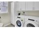 Bright laundry room featuring Whirlpool washer, dryer and white cabinetry at 2681 Park West Blvd, Mount Pleasant, SC 29466