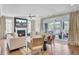 Bright living room with a fireplace, modern furniture, and seamless access to the screened porch through sliding glass doors at 2681 Park West Blvd, Mount Pleasant, SC 29466
