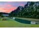 Scenic view of a pond with a water fountain and a house in the background at sunset at 2681 Park West Blvd, Mount Pleasant, SC 29466