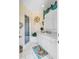 Bright bathroom featuring a shower, white vanity with marble countertop, and a decorative seashell wreath at 27 Waterway Island Dr, Isle of Palms, SC 29451
