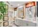 Elegant bathroom features double sinks, marble countertops, and abundant natural light at 27 Waterway Island Dr, Isle of Palms, SC 29451