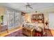 Comfortable bedroom with hardwood floors, a ceiling fan, and access to a balcony at 27 Waterway Island Dr, Isle of Palms, SC 29451