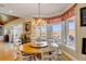 Bright dining area features a chandelier and scenic views, creating an elegant atmosphere at 27 Waterway Island Dr, Isle of Palms, SC 29451