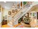 Grand foyer with hardwood floors, a sweeping staircase, and elegant decor throughout at 27 Waterway Island Dr, Isle of Palms, SC 29451