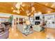Beautiful living room featuring wood ceiling, fireplace, custom shelving, and ample seating at 27 Waterway Island Dr, Isle of Palms, SC 29451