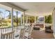 Spacious covered porch features ample seating and scenic backyard views at 27 Waterway Island Dr, Isle of Palms, SC 29451