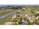 An aerial view of waterfront homes with private boat docks along a winding river at 28 Rebellion Rd, Charleston, SC 29407