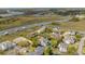 Aerial view of a neighborhood with waterfront access, docks, and marsh views at 28 Rebellion Rd, Charleston, SC 29407