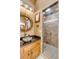 This updated bathroom includes a stone sink, granite countertops, and a tiled shower with a glass door at 28 Rebellion Rd, Charleston, SC 29407