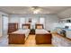 This bedroom has hardwood floors, two twin beds, a ceiling fan, and two windows at 28 Rebellion Rd, Charleston, SC 29407