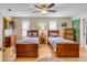 This bedroom has hardwood floors, two twin beds, a ceiling fan, and two windows at 28 Rebellion Rd, Charleston, SC 29407