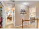 An upstairs hallway featuring wood floors and access to the bedrooms and bathrooms at 28 Rebellion Rd, Charleston, SC 29407